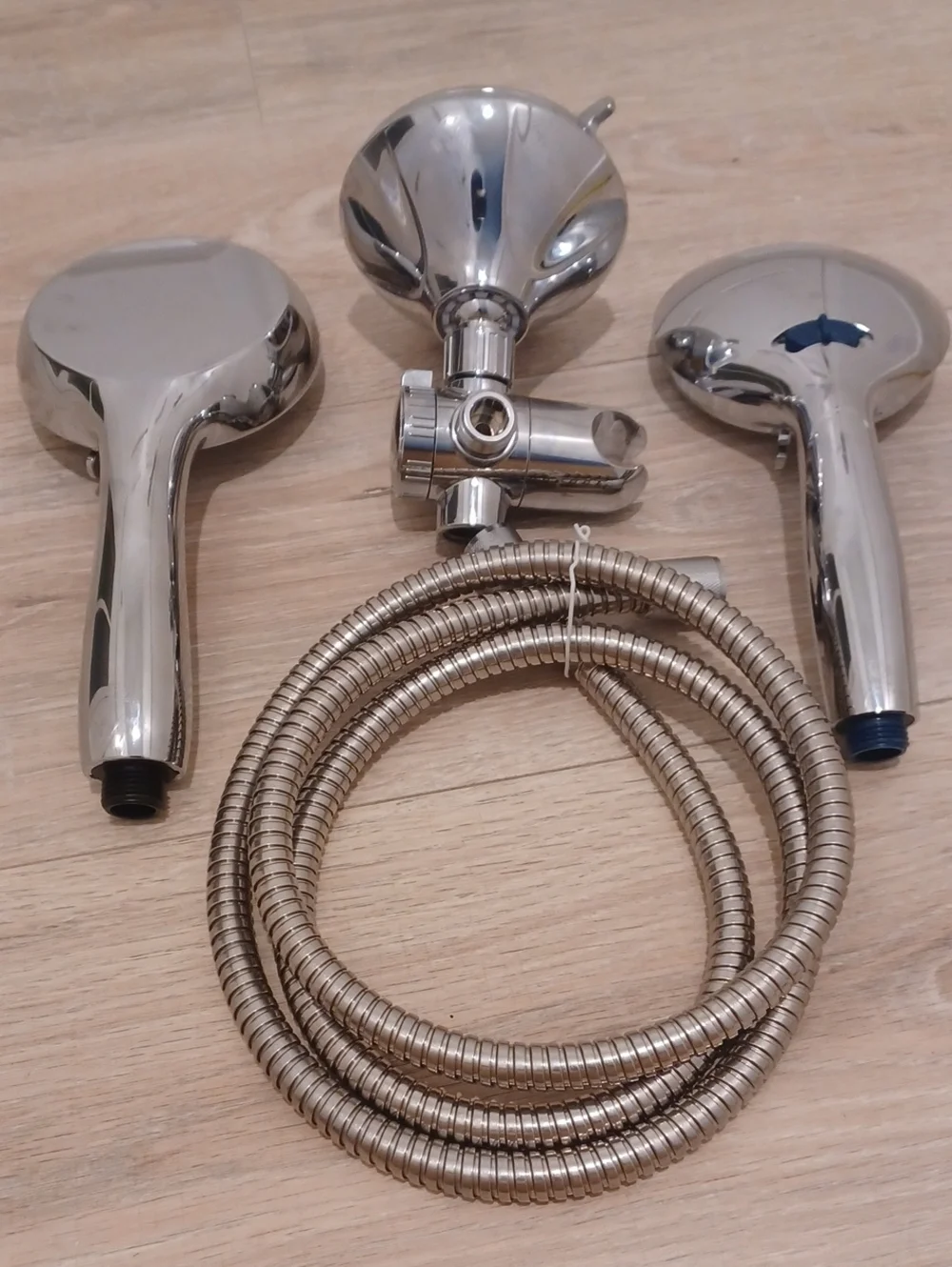 Bundle of chrome shower heads with flexible hose. Bath. Hand held.